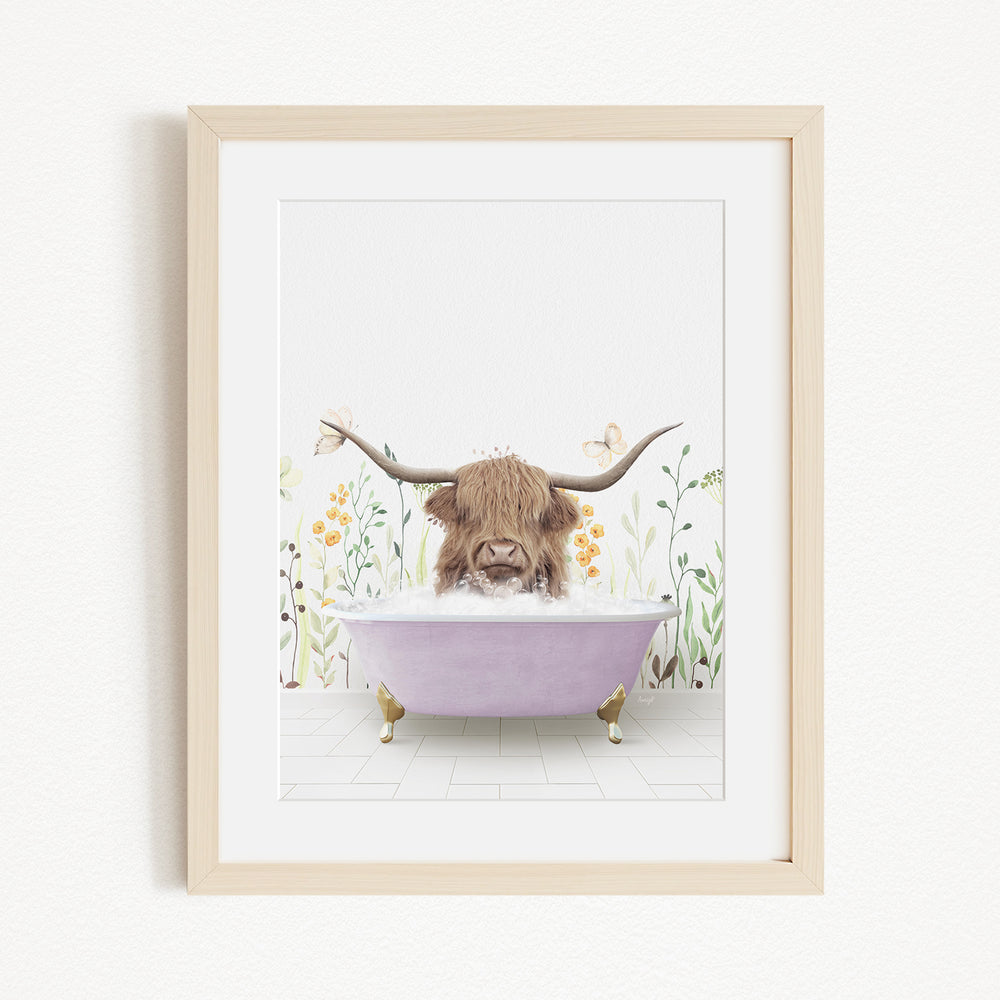 A framed illustration depicting a cow with long horns sitting in a purple bathtub, surrounded by flowers and plants.