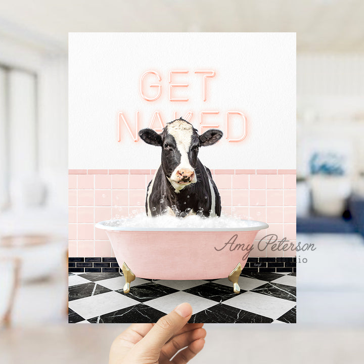 a person holding up a card with a picture of a cow in a bathtub