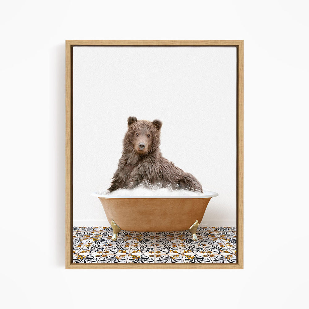 A brown bear sitting in a bathtub filled with bubbles, looking directly at the camera.