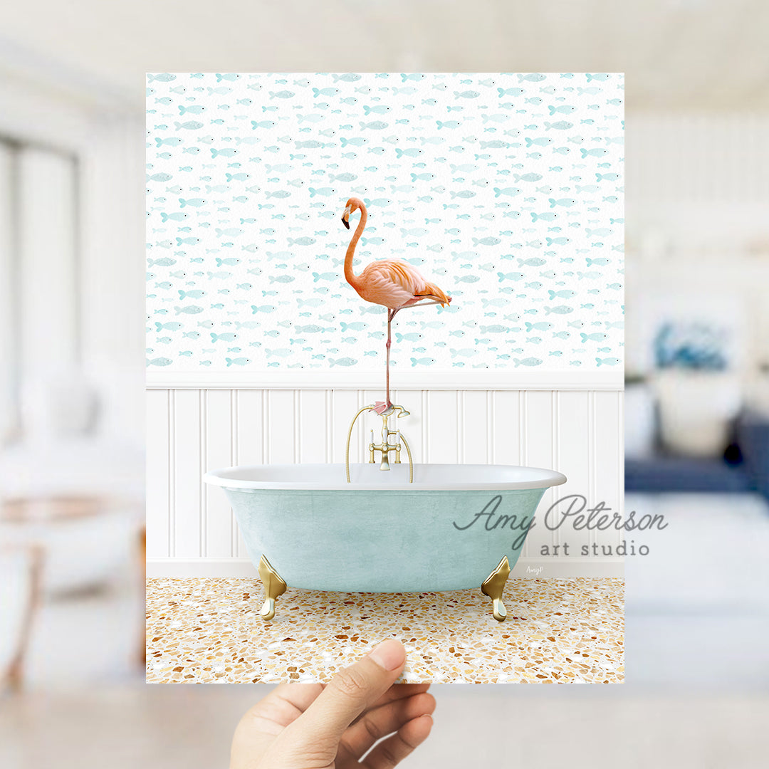 a person holding up a picture of a flamingo in a bathtub