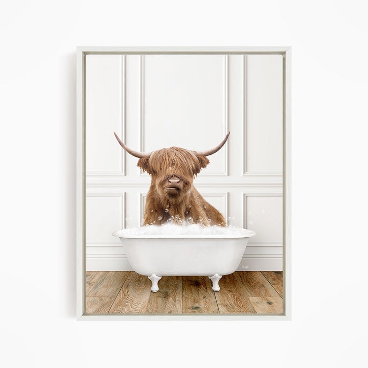 A brown cow with long horns is sitting in a white bathtub filled with water, creating a whimsical and playful scene.