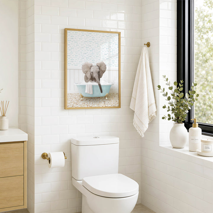 A bathroom with a white toilet, a framed picture of an elephant in a bathtub, and a towel rack with a towel.
