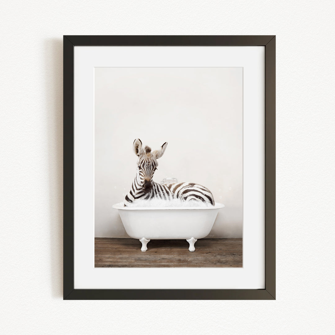 A zebra lying in a white bathtub, with its head resting on the edge of the tub.