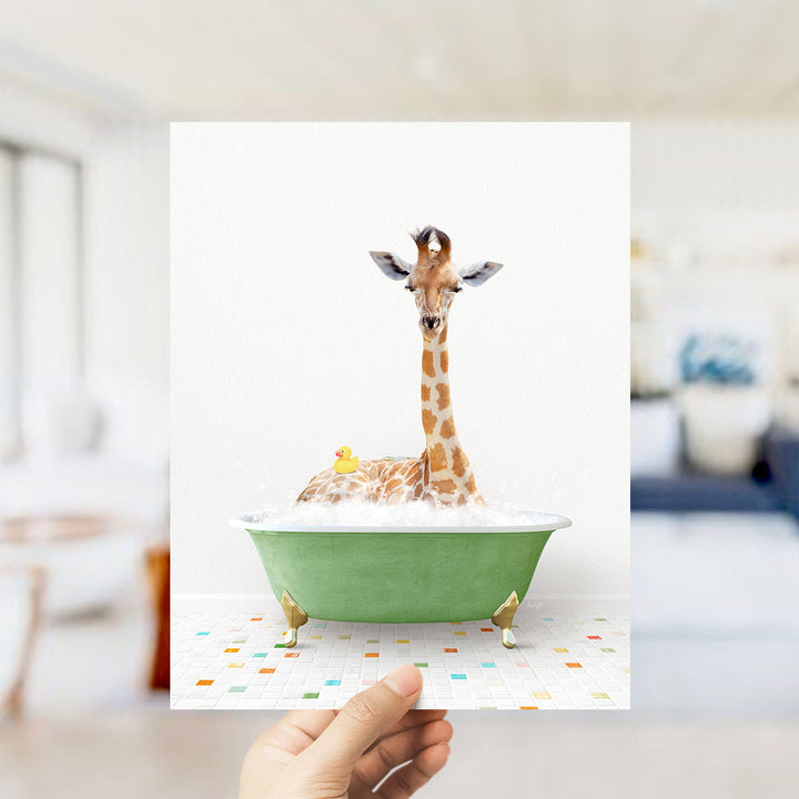 A giraffe sitting in a green bathtub filled with bubbles, with a rubber duck floating in the water.