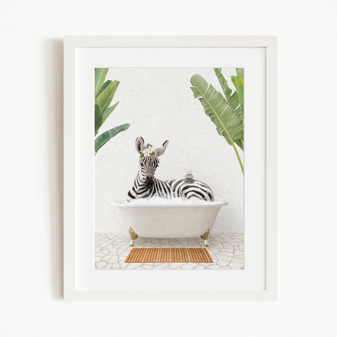 A zebra is sitting in a white bathtub, surrounded by green leaves, creating a whimsical and playful scene.