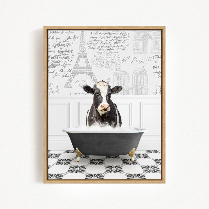 A black and white cow is sitting in a bathtub filled with water, surrounded by a black and white tiled floor and a wall with various inscriptions and drawings.