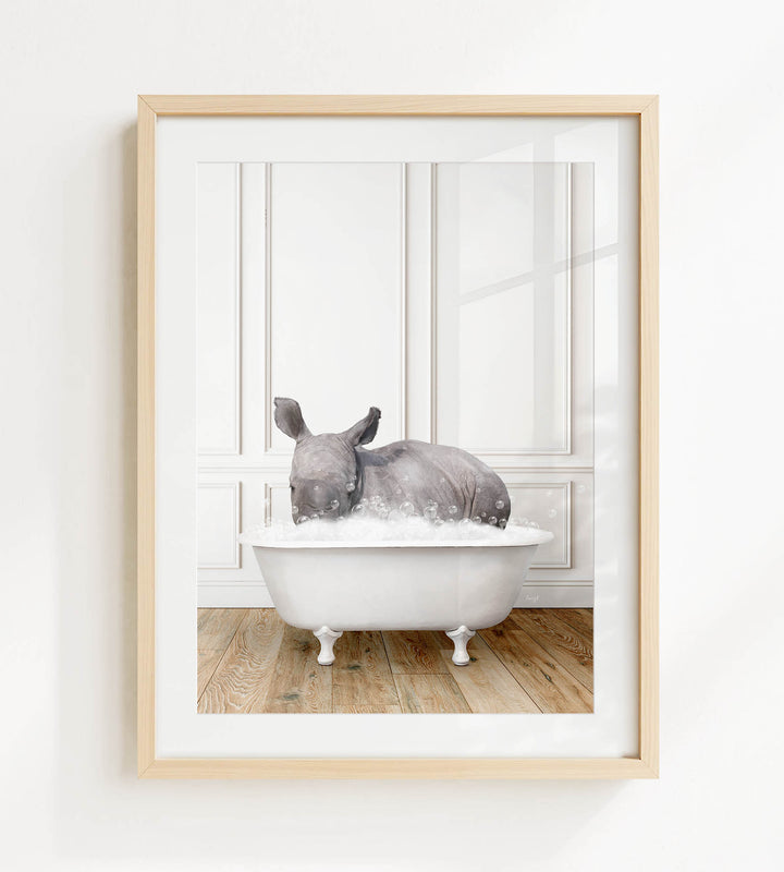 A rhinoceros is sitting in a white bathtub filled with water, creating a whimsical and playful scene.
