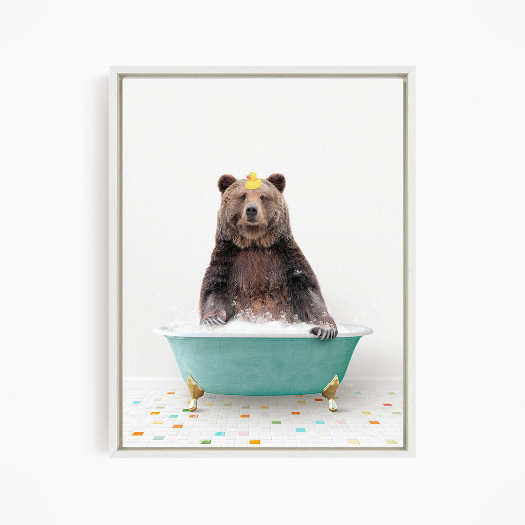 A brown bear sitting in a green bathtub filled with water, with a yellow rubber duck floating on the water.
