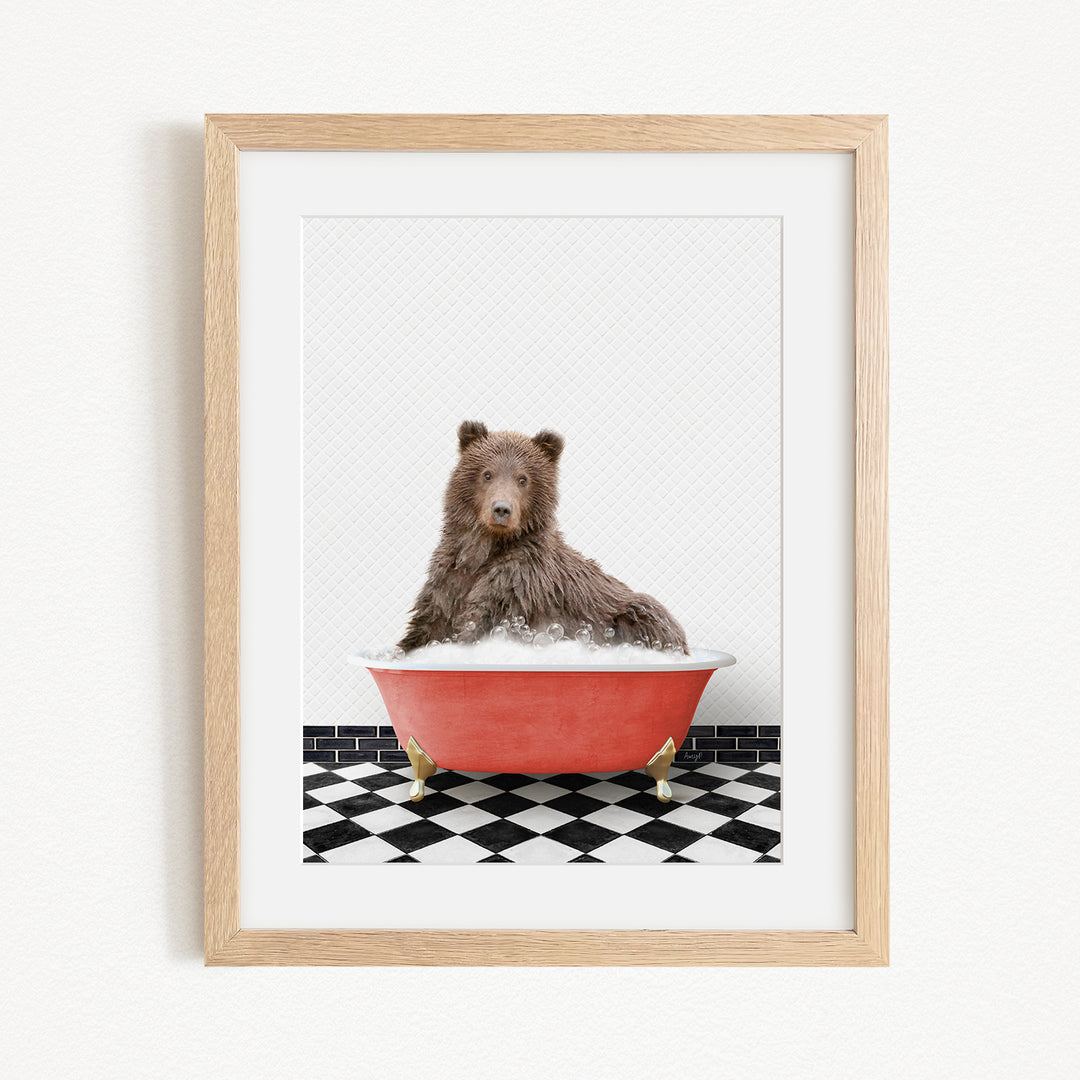 A brown bear sitting in a red bathtub on a black and white checkered floor.