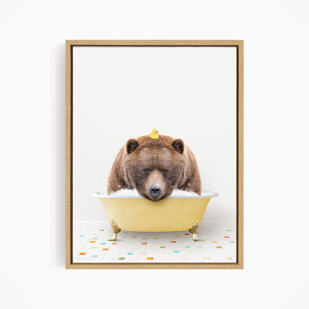 A brown bear is sitting in a yellow bathtub, with a rubber duck perched on its head.