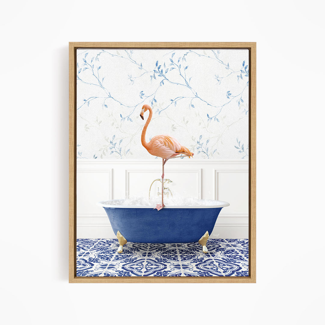 A pink flamingo stands on the edge of a blue bathtub, with a patterned tile floor and a floral wallpaper in the background.