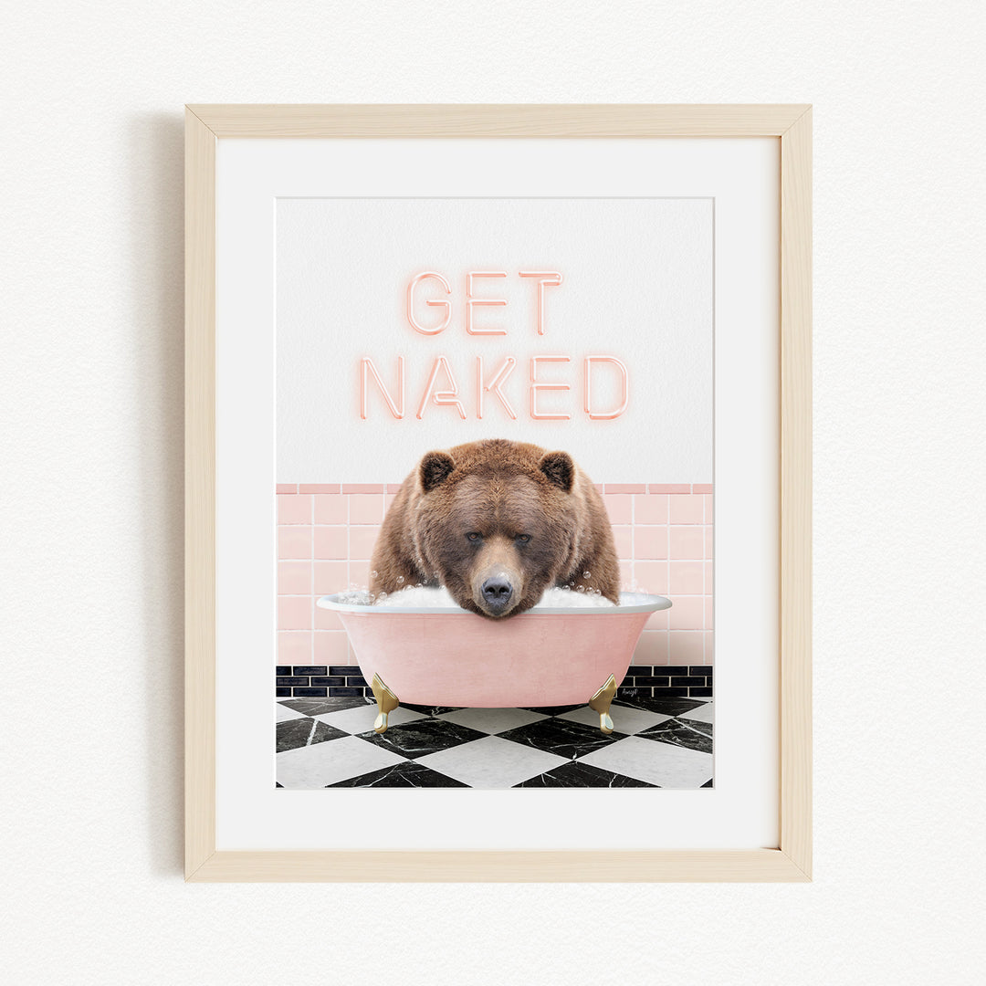 A framed image depicting a brown bear sitting in a pink bathtub with the text "GET NAKED" written above it.