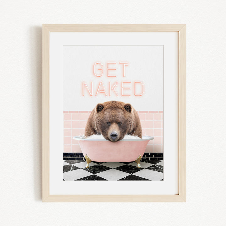 A framed image depicting a brown bear sitting in a pink bathtub with the text "GET NAKED" written above it.