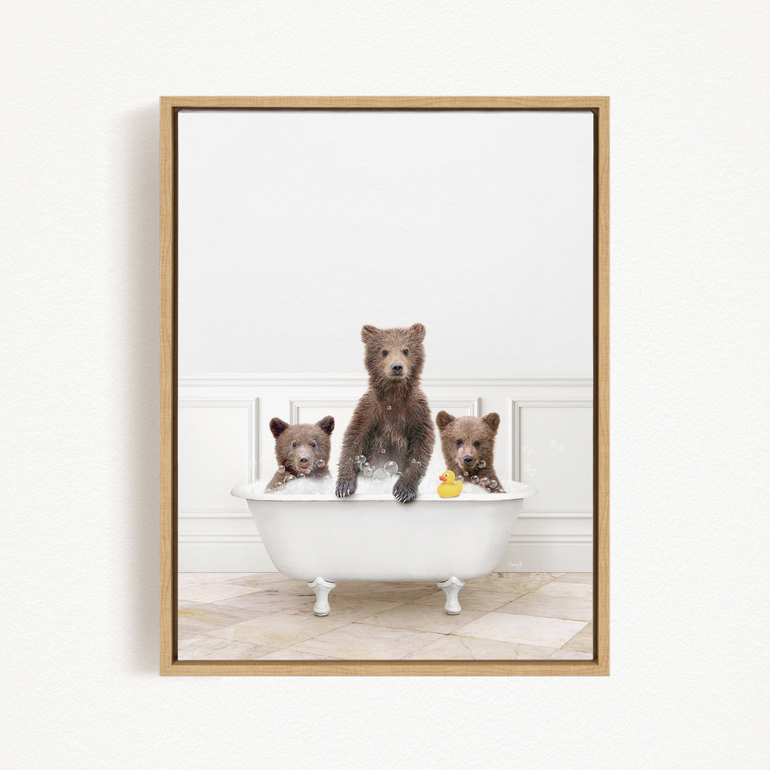 A framed image showing three bears sitting in a white bathtub, with one bear holding a rubber duck.