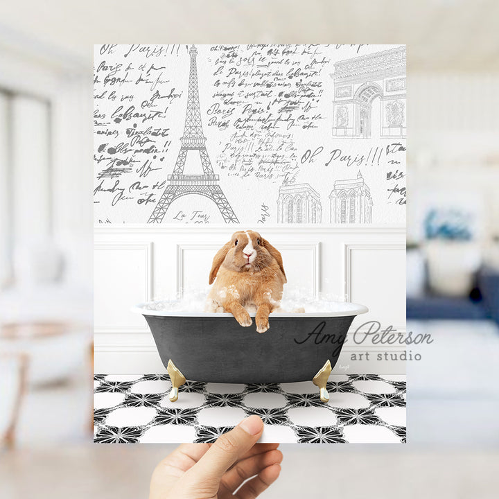 a person holding up a card with a picture of a rabbit in a bathtub