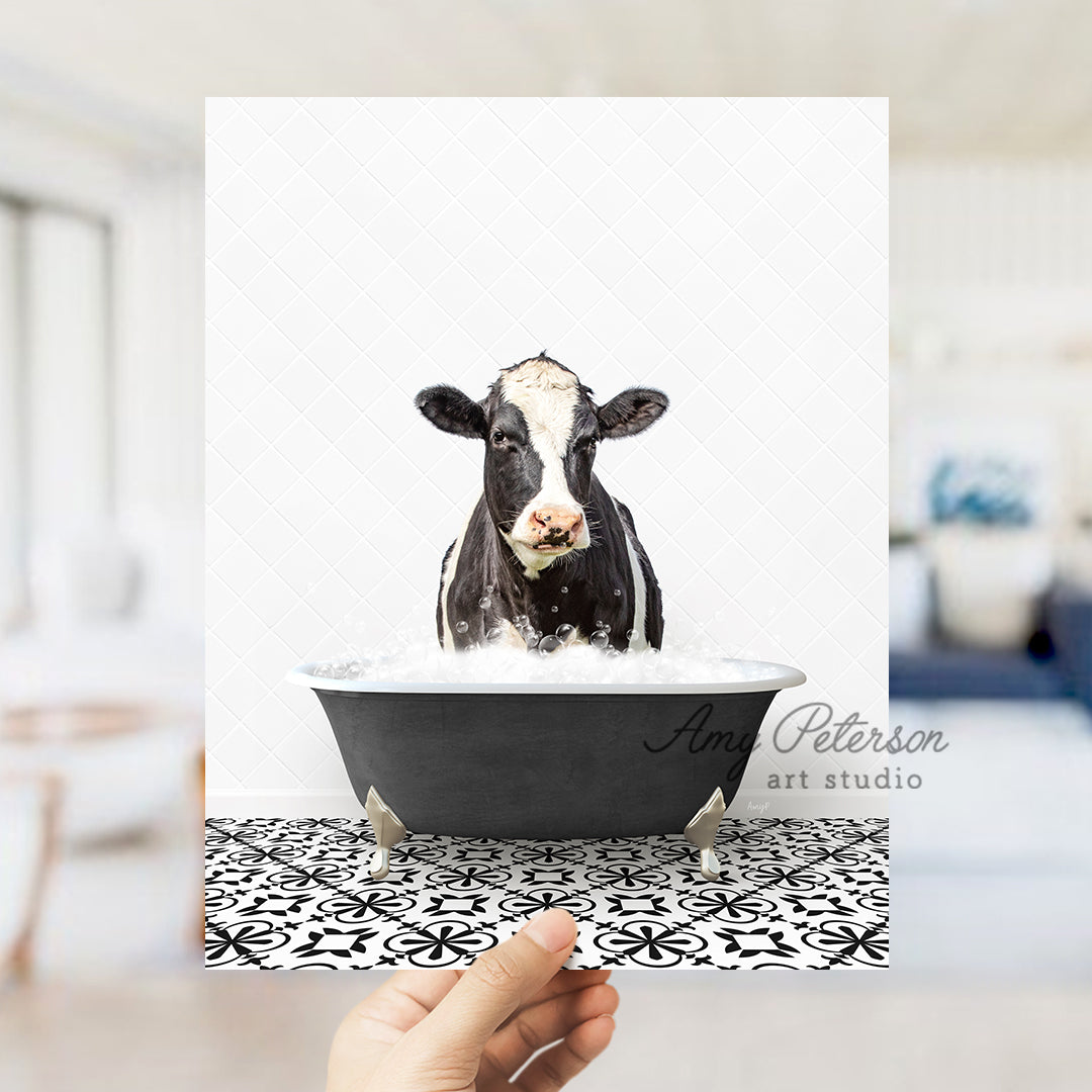 a person holding up a card with a picture of a cow in a bathtub