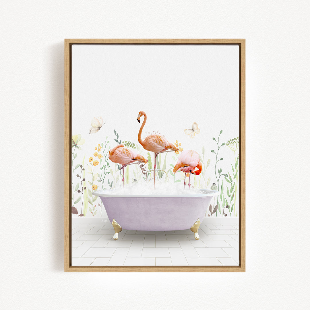 A framed illustration depicting three flamingos sitting in a bathtub filled with bubbles, surrounded by flowers and butterflies.
