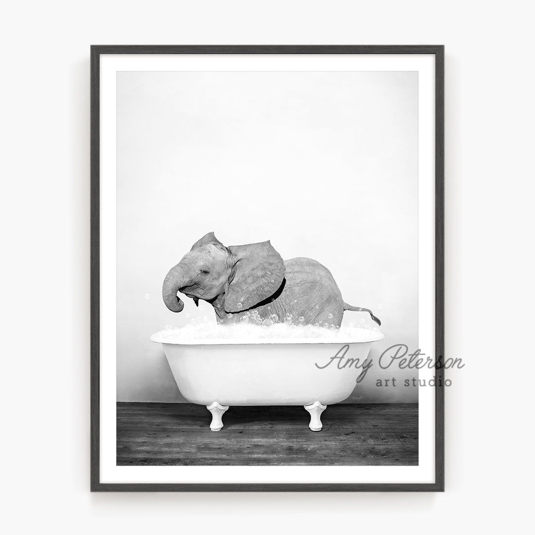 a black and white photo of an elephant in a bathtub