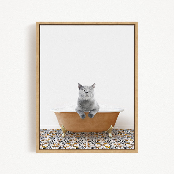 A gray cat sitting in a bathtub filled with bubbles, with a patterned tile floor beneath it.