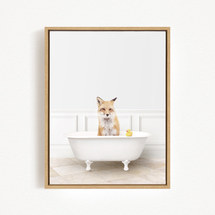 A fox is sitting in a white bathtub, with a yellow rubber duck floating in the water.