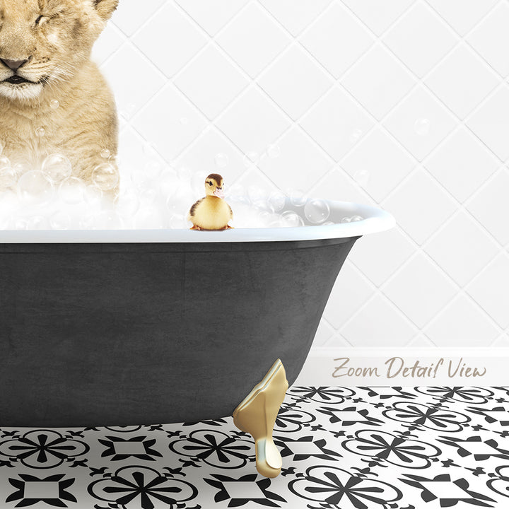 A lion cub is sitting in a bathtub filled with bubbles, while a small yellow duck is perched on the edge of the tub.