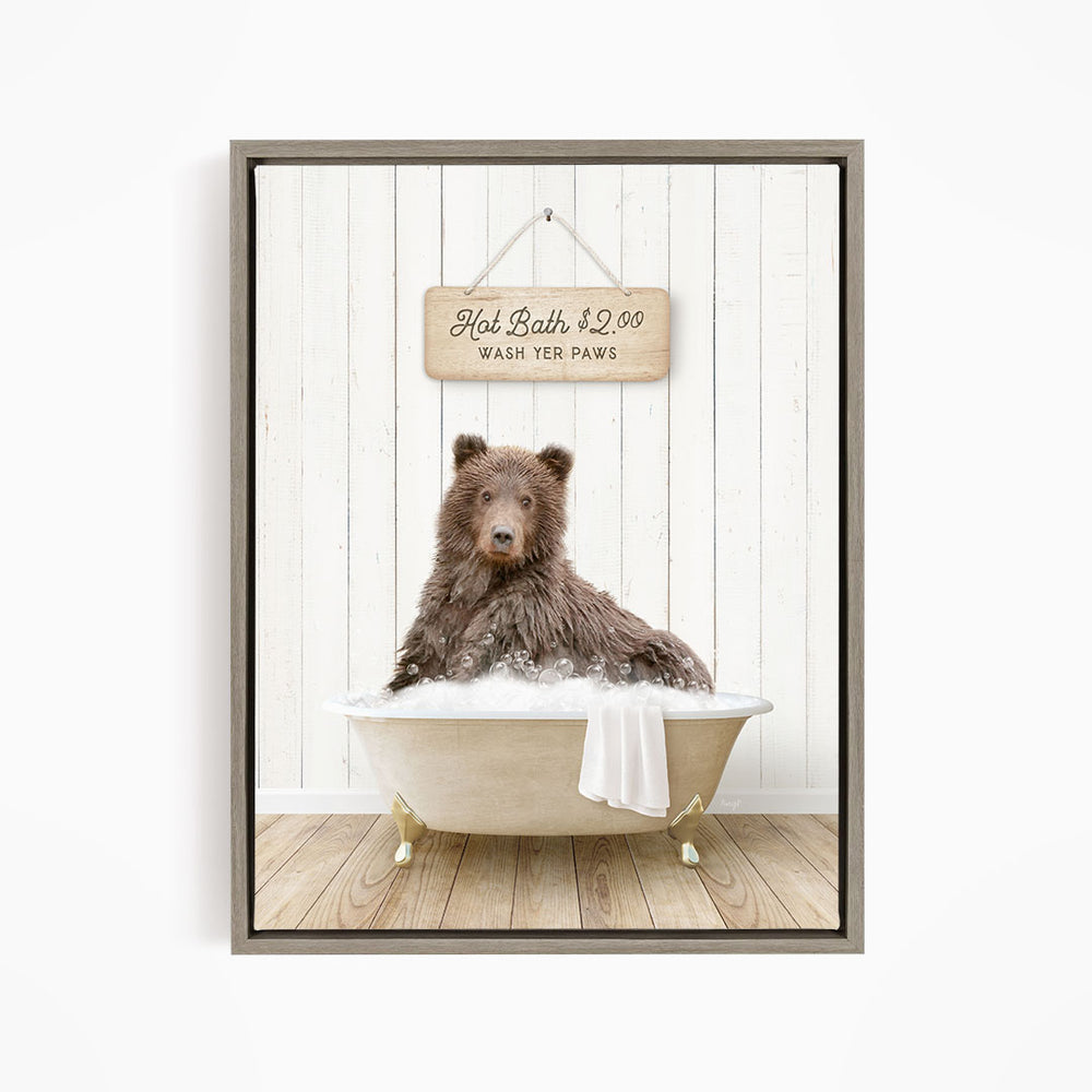 A brown bear sitting in a bathtub filled with water, with a sign above the bear that reads "Hot Bath $2.00 Wash Your Paws".