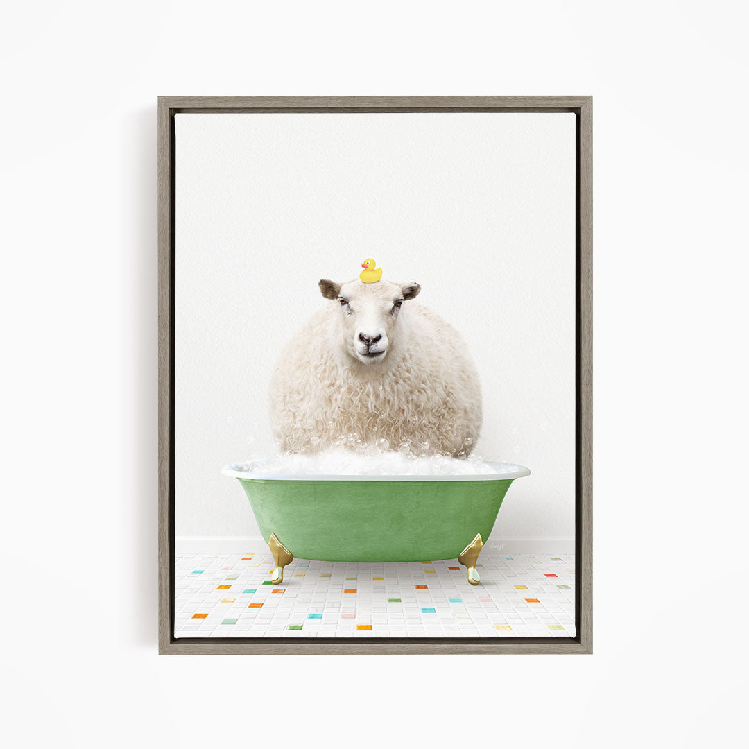 A fluffy white sheep sits in a green bathtub filled with bubbles, with a yellow rubber duck perched on its head.