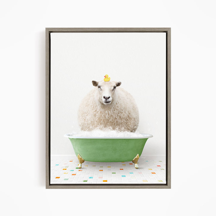 A fluffy white sheep sits in a green bathtub filled with bubbles, with a yellow rubber duck perched on its head.