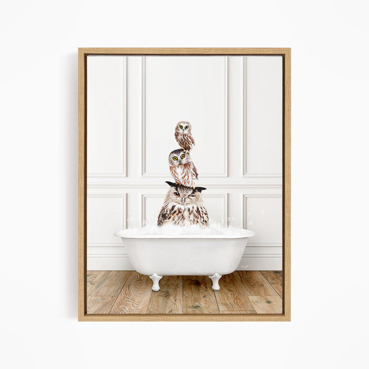 A framed image depicting three owls sitting in a white bathtub, with the top owl perched on the rim of the tub.