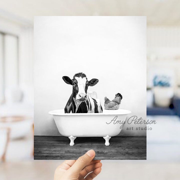 a black and white photo of a cow in a bathtub