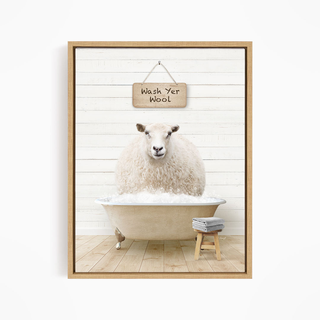 A fluffy white sheep is sitting in a bathtub filled with water, with a sign above it that says "Wash Yer Wool".