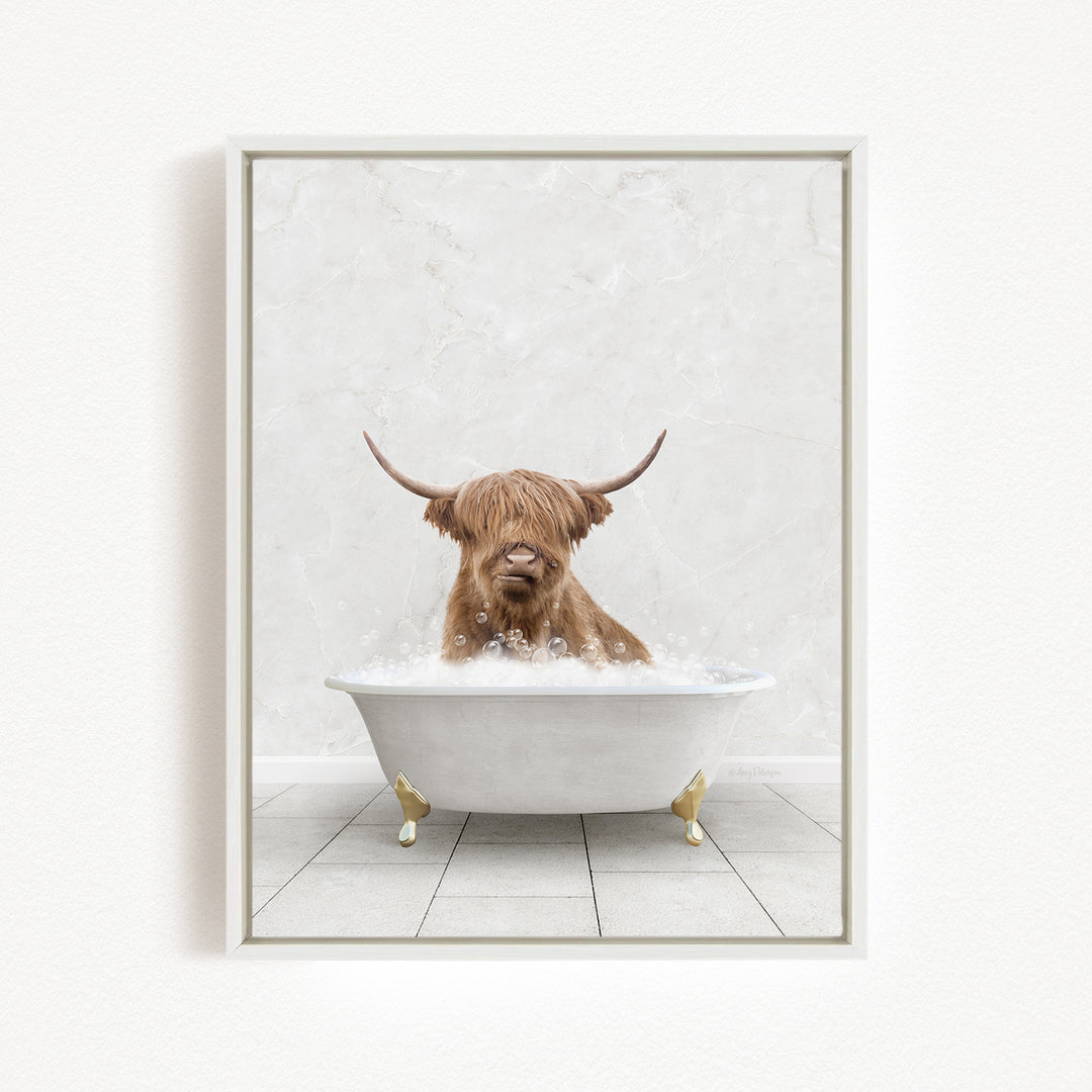 A Highland cow with long horns is sitting in a white bathtub filled with bubbles, creating a whimsical and playful scene.