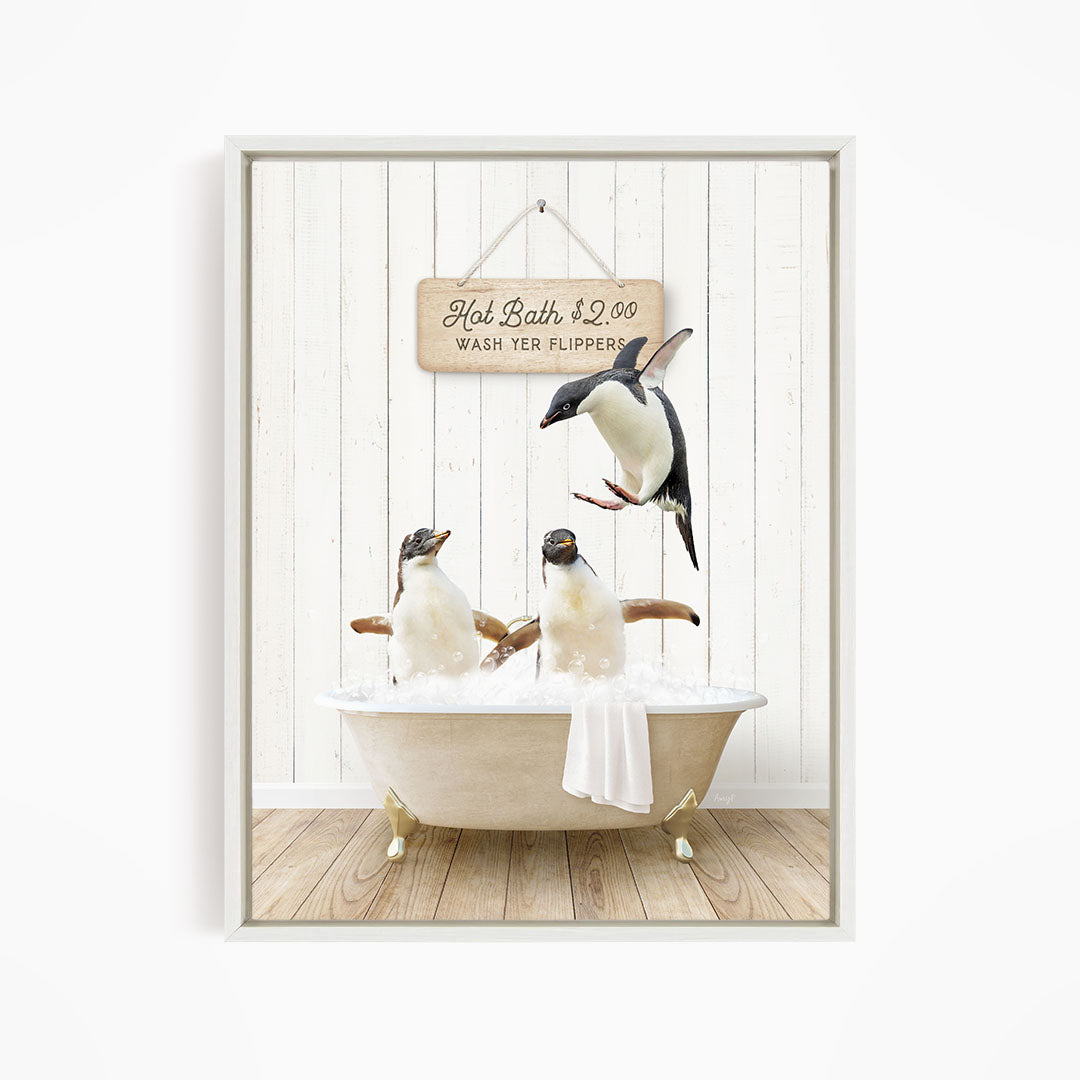 A framed image depicting three penguins sitting in a bathtub, with one penguin flying above the tub and another penguin sitting on the edge of the tub.