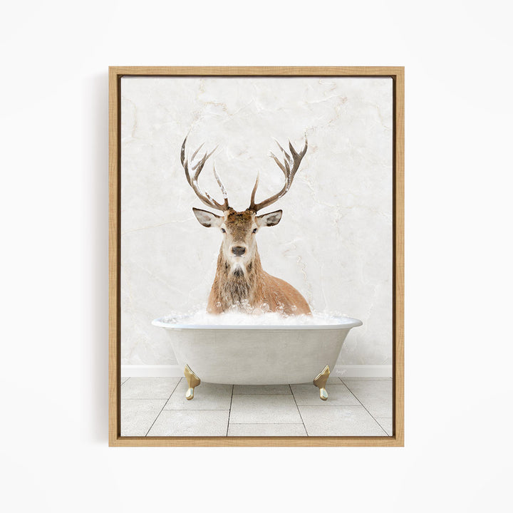 A deer with large antlers is sitting in a white bathtub, surrounded by bubbles, in the image.