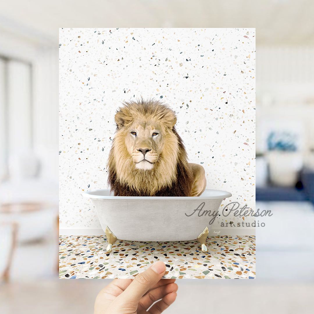 a lion sitting in a bathtub with a hand holding it