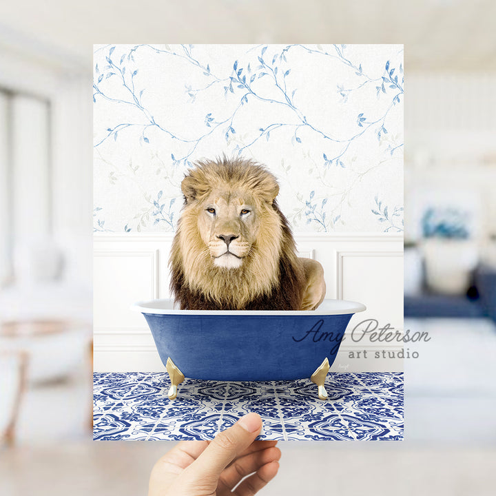 a hand holding a card with a picture of a lion in a bathtub