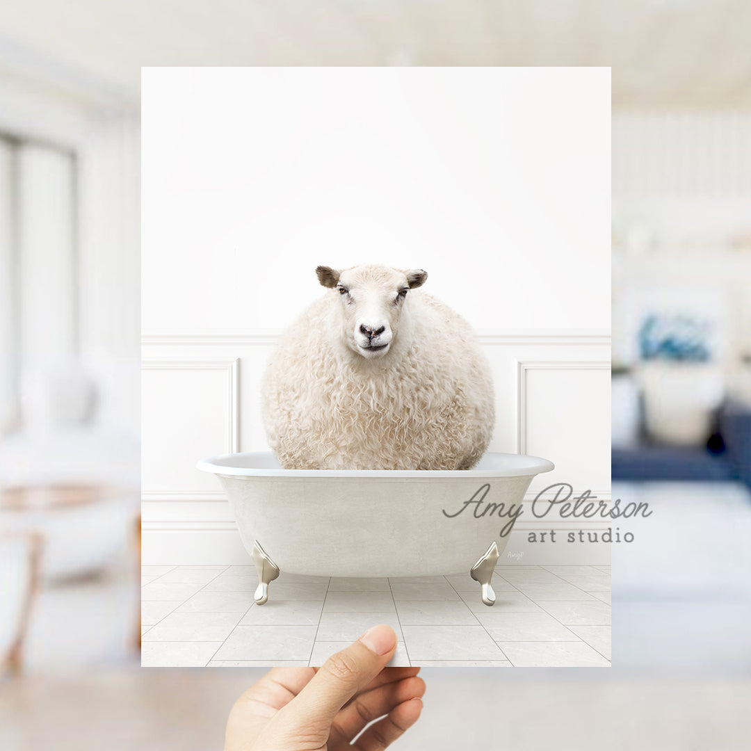 a hand holding a card with a sheep in a bathtub