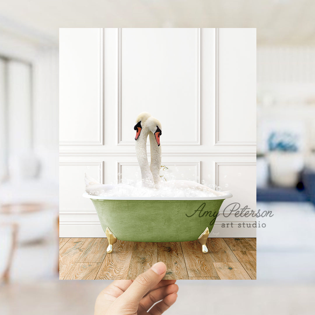 a person holding a card with a picture of two swans in a bathtub