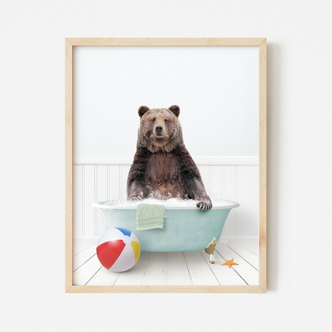 a bear sitting in a bathtub with a beach ball