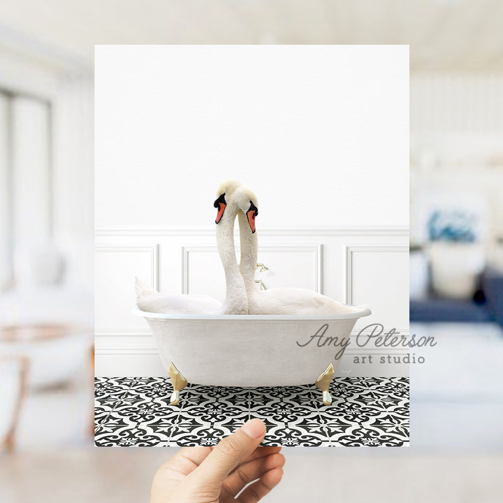 a person holding up a picture of a swan in a bathtub