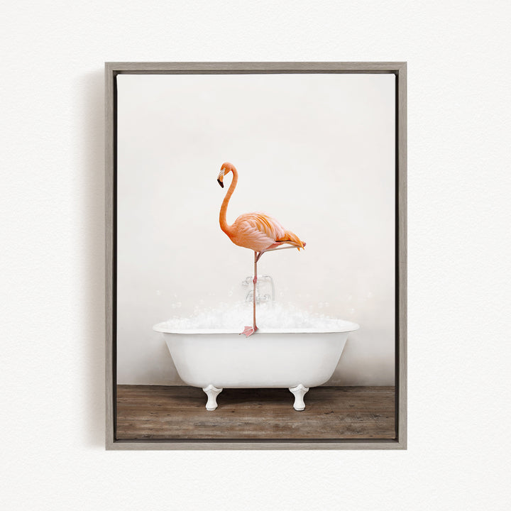 A vibrant orange flamingo stands on the edge of a white bathtub, creating a whimsical and playful scene.