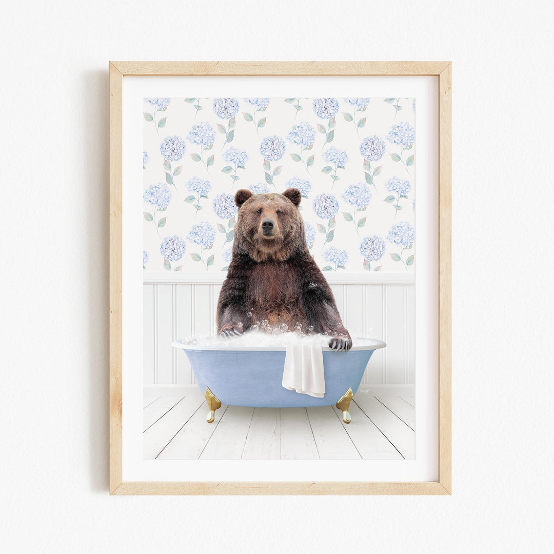 A brown bear sitting in a blue bathtub filled with water, surrounded by a floral pattern on the wall behind it.