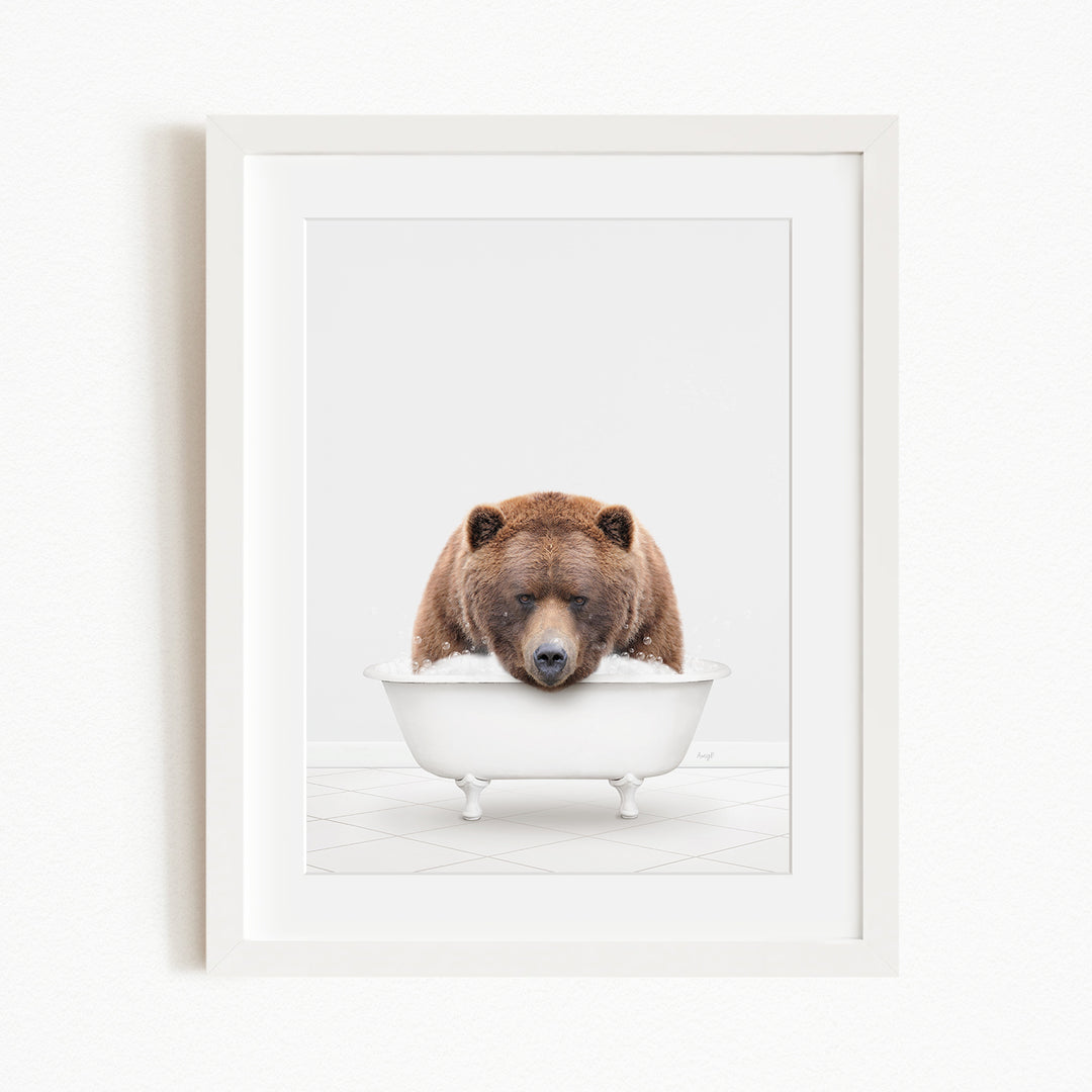 A brown bear is sitting in a white bathtub, appearing to be enjoying a relaxing bath.