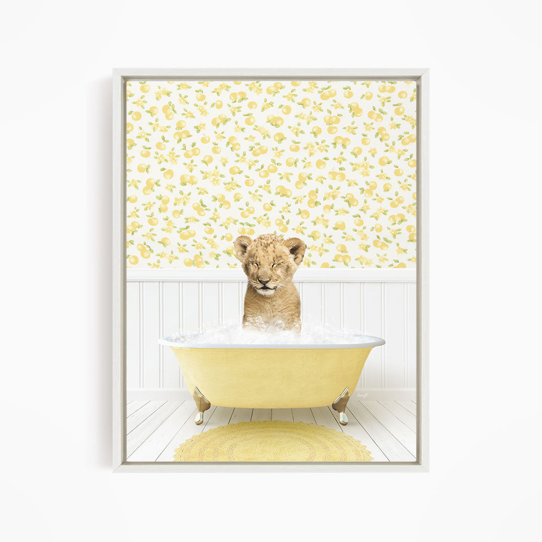 A young lion cub sitting in a yellow bathtub filled with water, surrounded by a yellow and white floral wallpaper.
