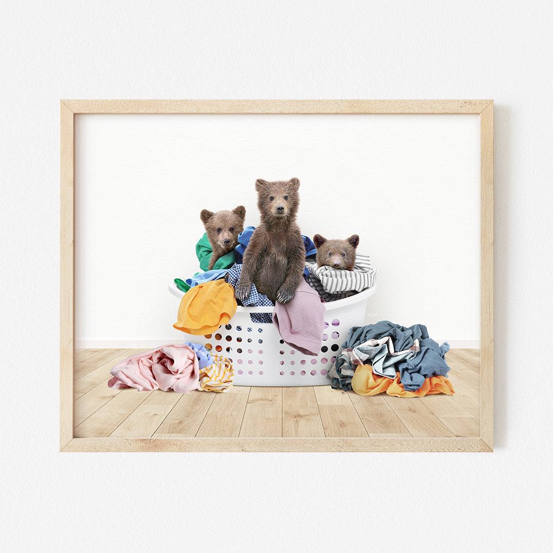 three teddy bears sitting in a laundry basket