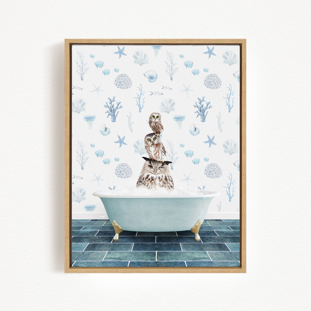 A framed print depicting a scene with a bathtub filled with water, where two owls are sitting and enjoying the warm water. The background features a pattern of blue and white marine life, including starfish, seashells, and coral.