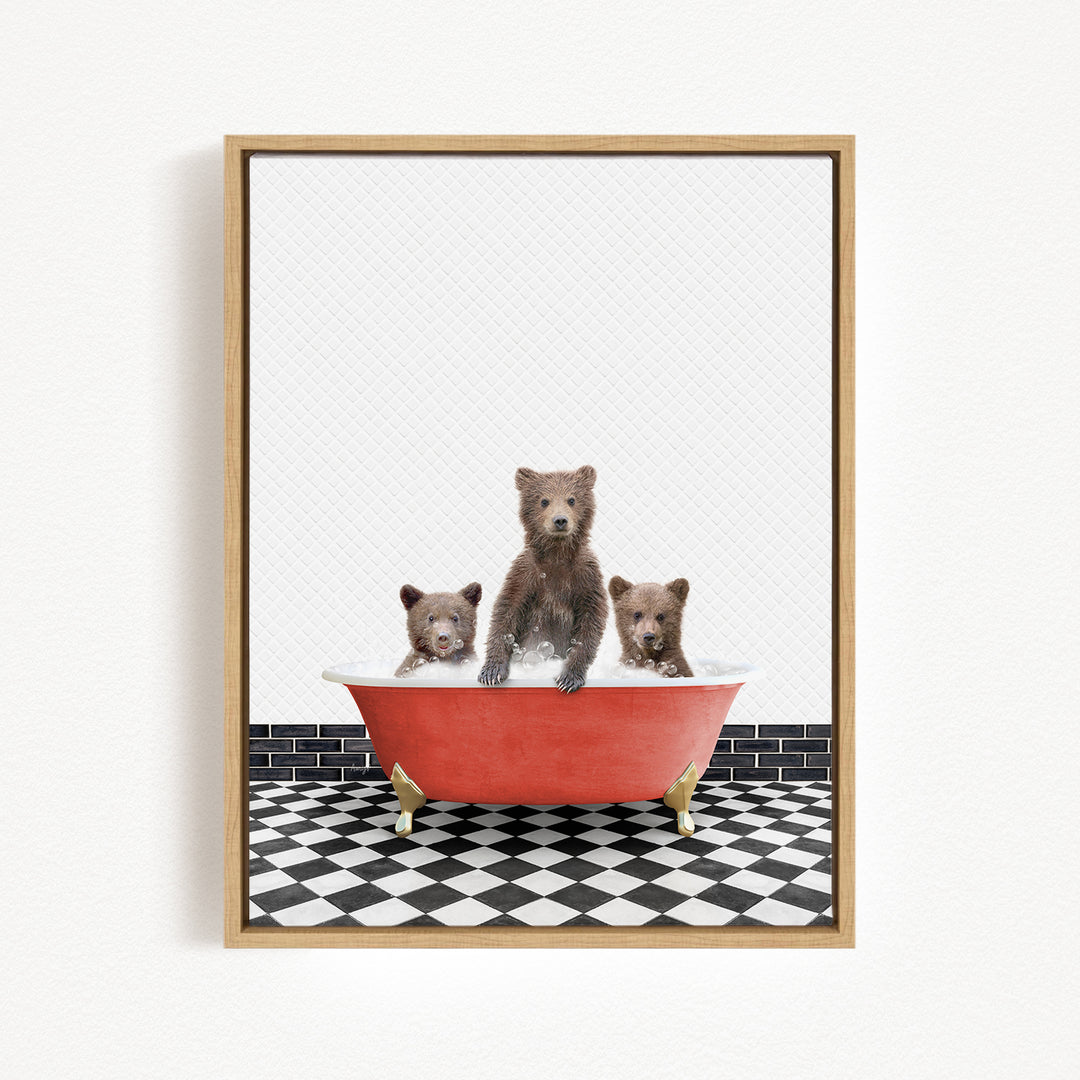 A framed image depicting three brown bears sitting in a red bathtub on a black and white checkered floor.