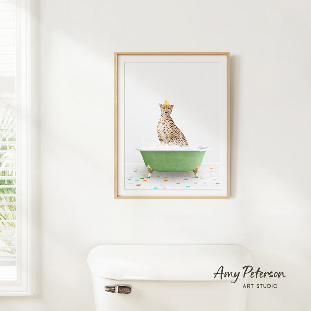 A cheetah sitting in a green bathtub, wearing a crown, is the central focus of the framed artwork displayed on the wall.