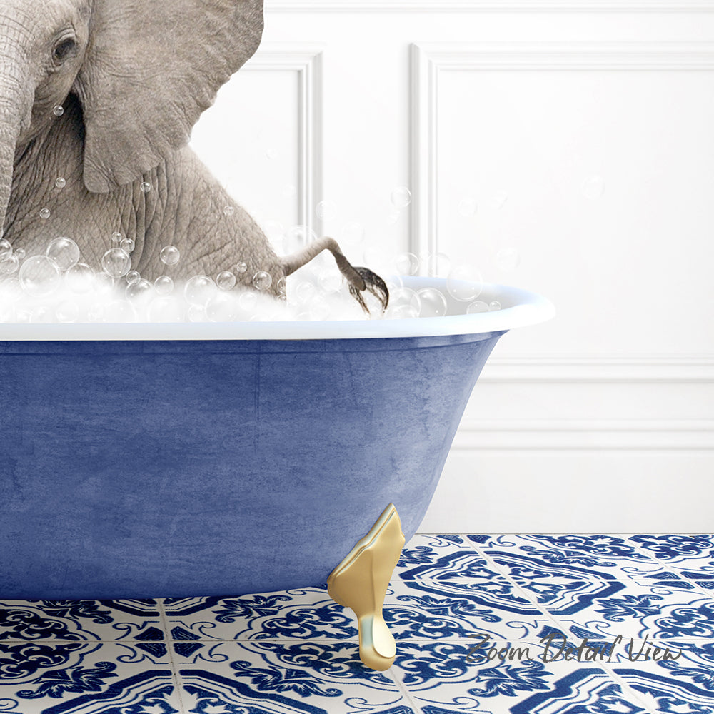 A gray elephant is standing in a blue bathtub filled with bubbles, with a gold bathtub faucet visible.