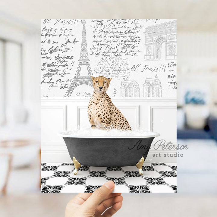 a hand holding up a card with a cheetah sitting in a bathtub